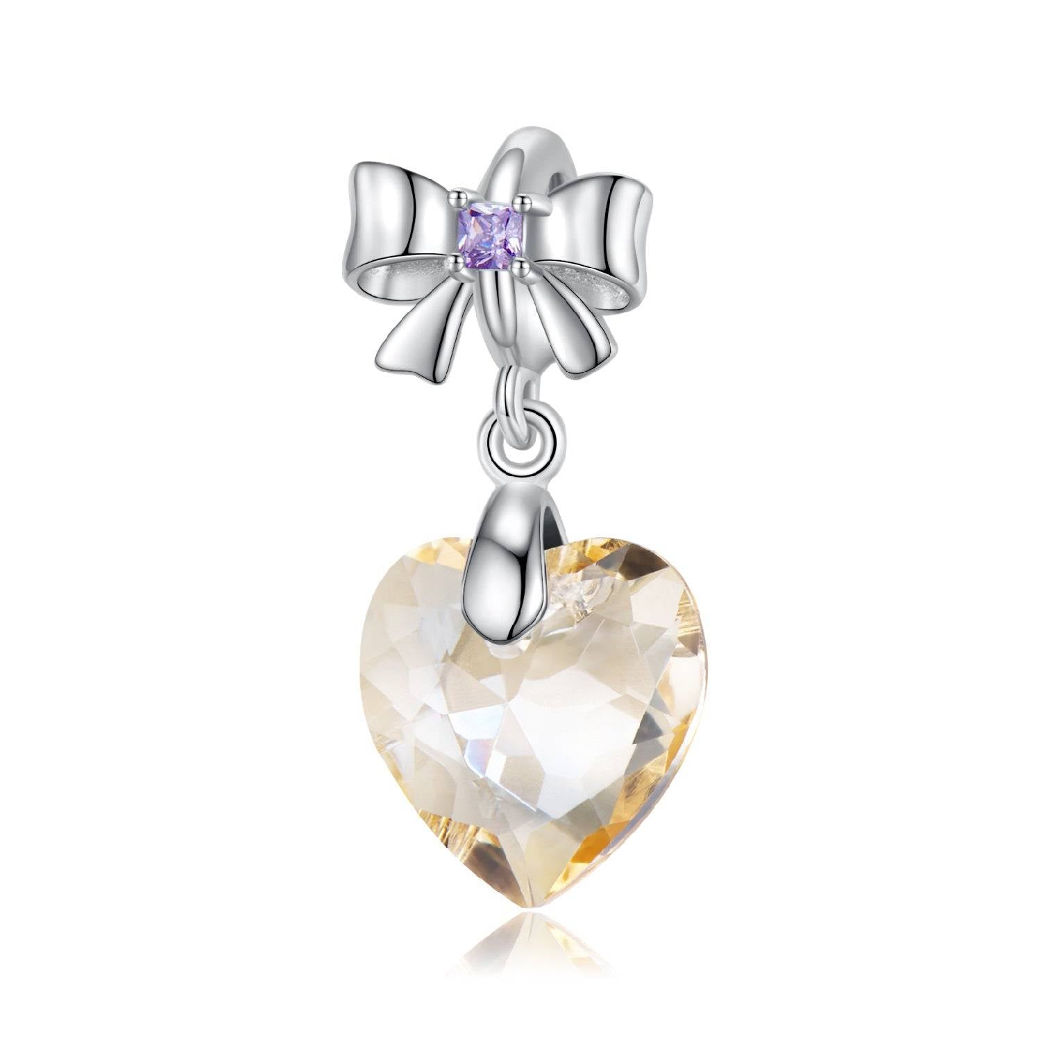 Golden Crystal Charm with heart-shaped gemstone and silver bow accent, perfect for bracelets and necklaces. Save up to 20% now.