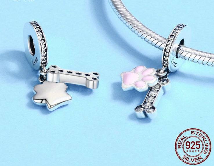 Close-up of Pink Bone Charm in sterling silver with pink paw and diamanté bone, showcasing its intricate pet-inspired design.