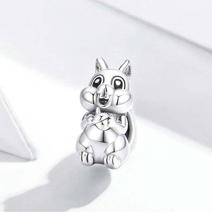 Adorable silver squirrel charm on white background