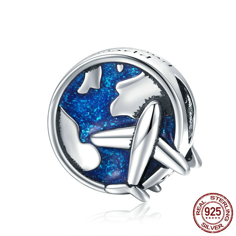 Sterling silver Travel Charm with a blue enamel globe and airplane design, symbolizing adventure and protection. Perfect for charm bracelets.