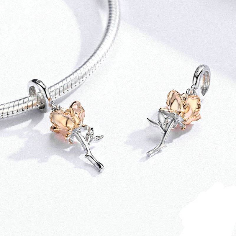 Pair of gold rose charms with silver stems