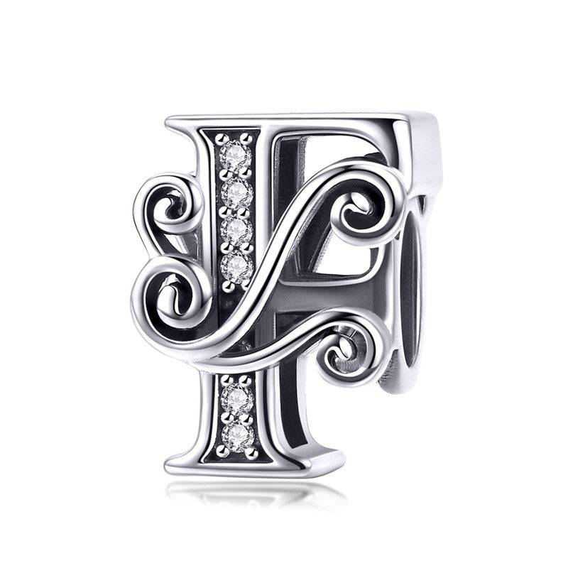 Intricate letter F charm with embellishments