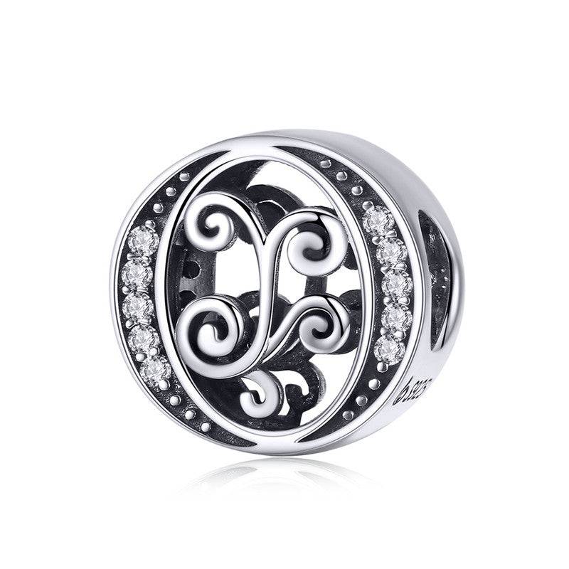 Round letter charm with ornate detailing