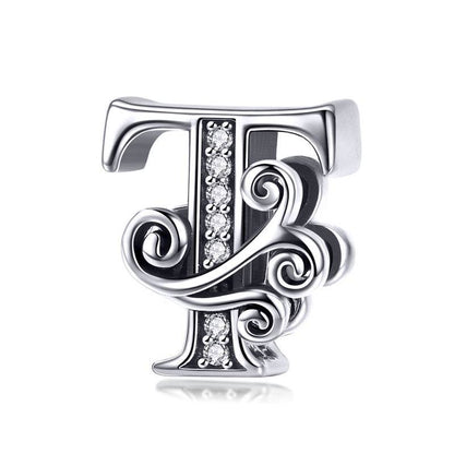 Ornate letter T charm with swirl design