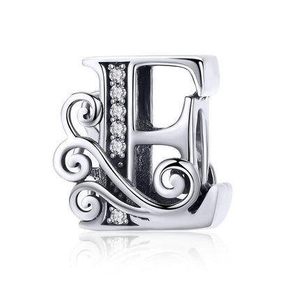 Ornate letter E charm with swirl design