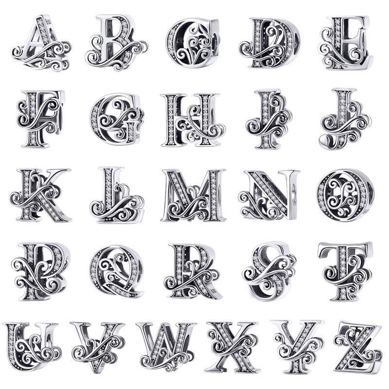 Alphabet letter charms with intricate designs