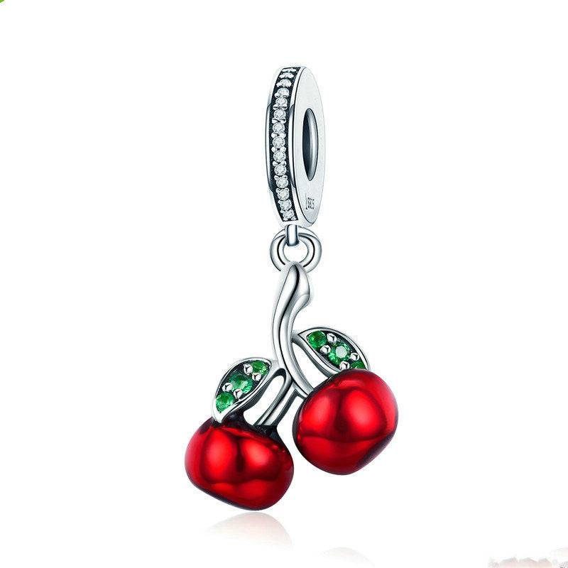 Cherry Charm featuring red cherries with green leaf accents, crafted in sterling silver with a crystal-studded bail. A vibrant addition to any jewelry collection.