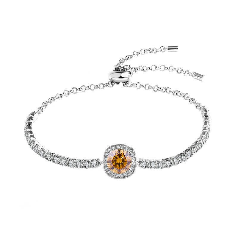 Silver moissanite galaxy bracelet with a yellow central stone, showcasing a celestial-inspired design and adjustable chain.