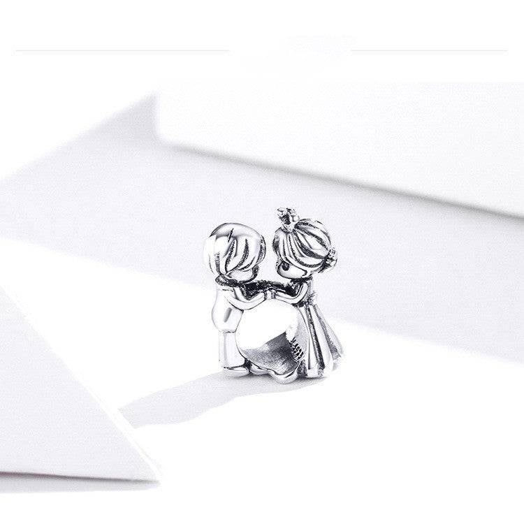 Detailed view of couple charm in silver