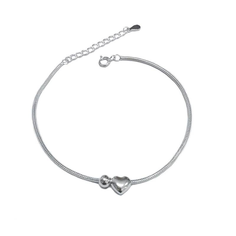 Heart Bead Silver Bracelet featuring a delicate silver chain with a heart-shaped charm, perfect for romantic and timeless jewelry lovers.