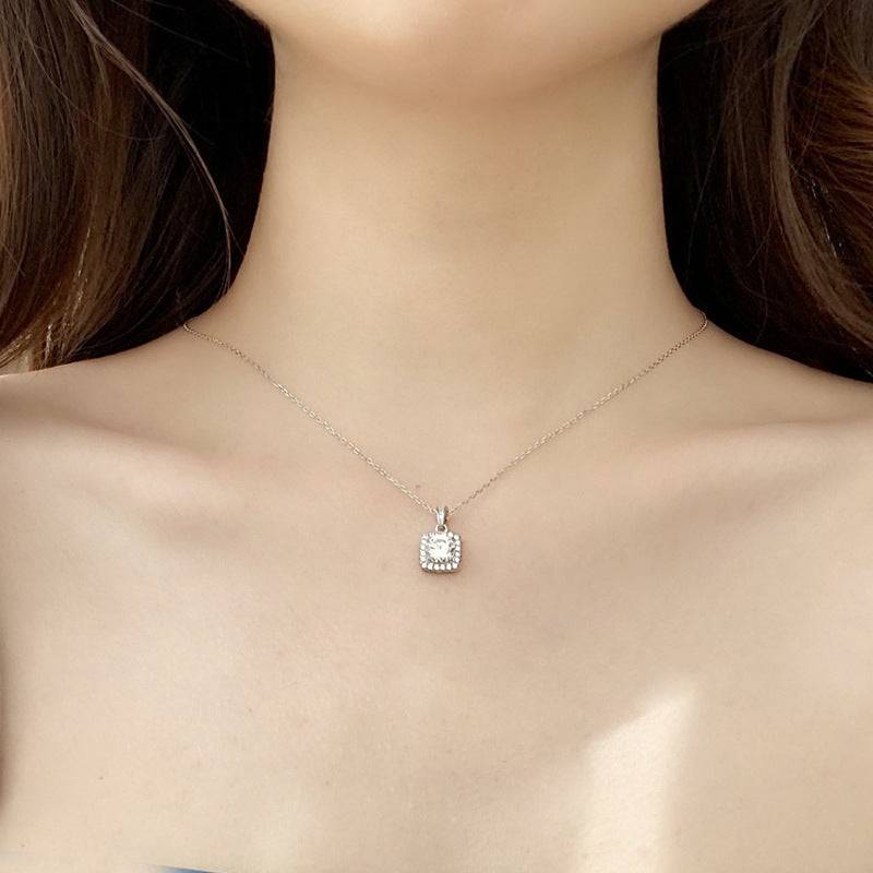 Model wearing a square pendant moissanite necklace with a silver chain, showcasing its elegant design.