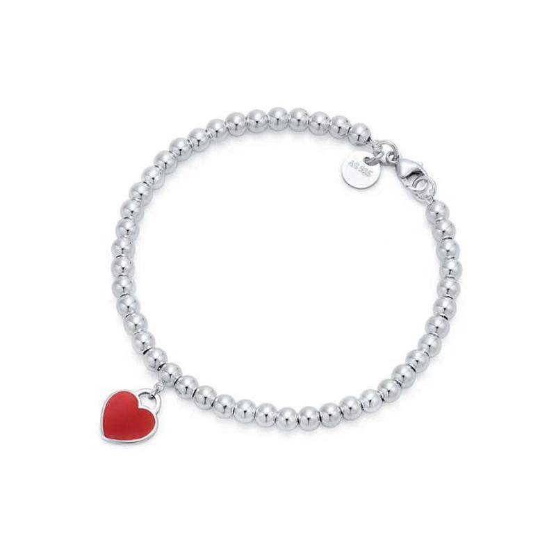 Silver bracelet with red heart tag pendant