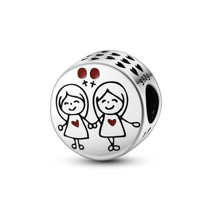 Round charm with two girls holding hands