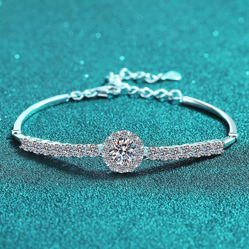 Elegant Silver Moissanite Bangle with a central moissanite stone and shimmering accents, perfect for adding luxury to any outfit.