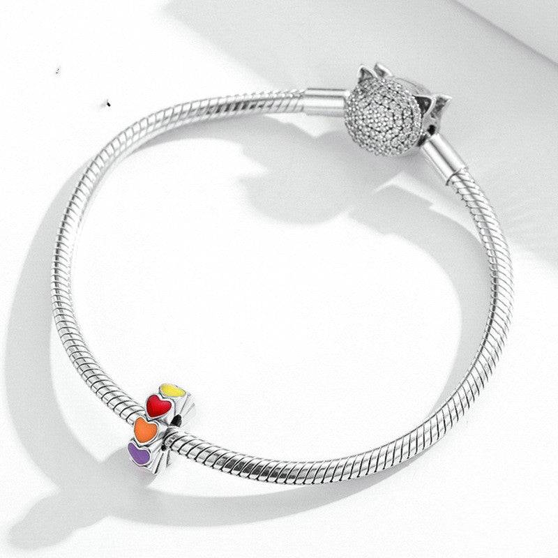 Bracelet featuring a rainbow heart charm spacer