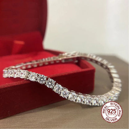 Silver tennis bracelet displayed in a red box.