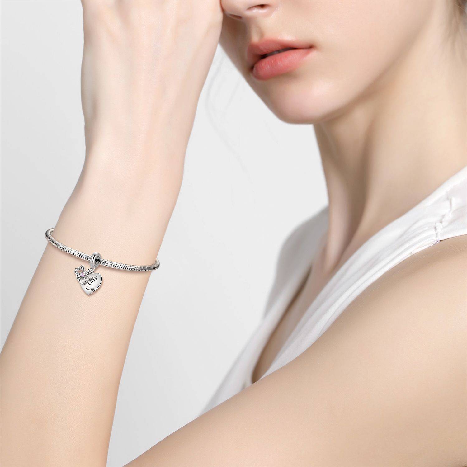 Woman wearing bracelet with Gift of Love Charm