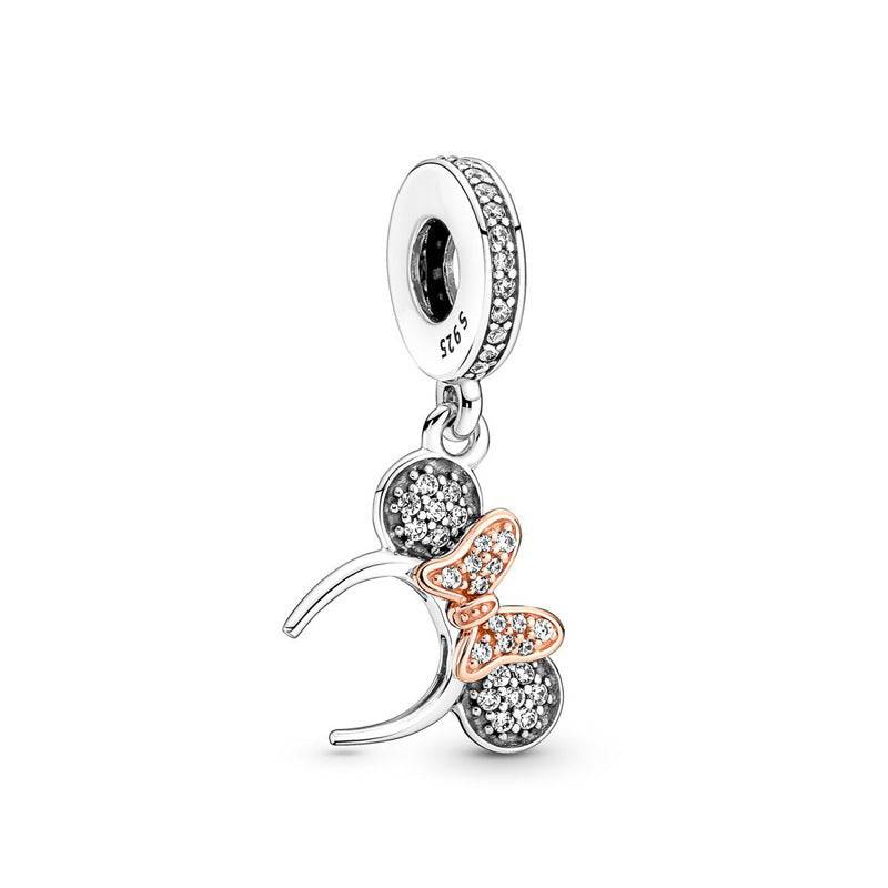 Disney Charm featuring sparkling crystals and a rose gold bow, inspired by iconic Disney symbols. A perfect collectible for Disney fans.