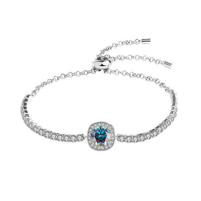 Silver moissanite galaxy bracelet with a blue central stone and sparkling accents, showcasing a celestial theme.