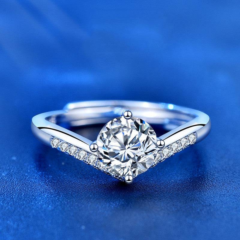 Elegant Princess Crown Silver Moissanite Ring with a V-shaped silver band. Features a 1 carat moissanite stone and sparkling accent stones.