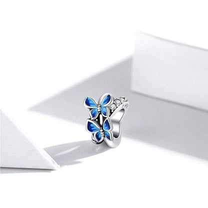 Charming butterfly spacer with blue accents