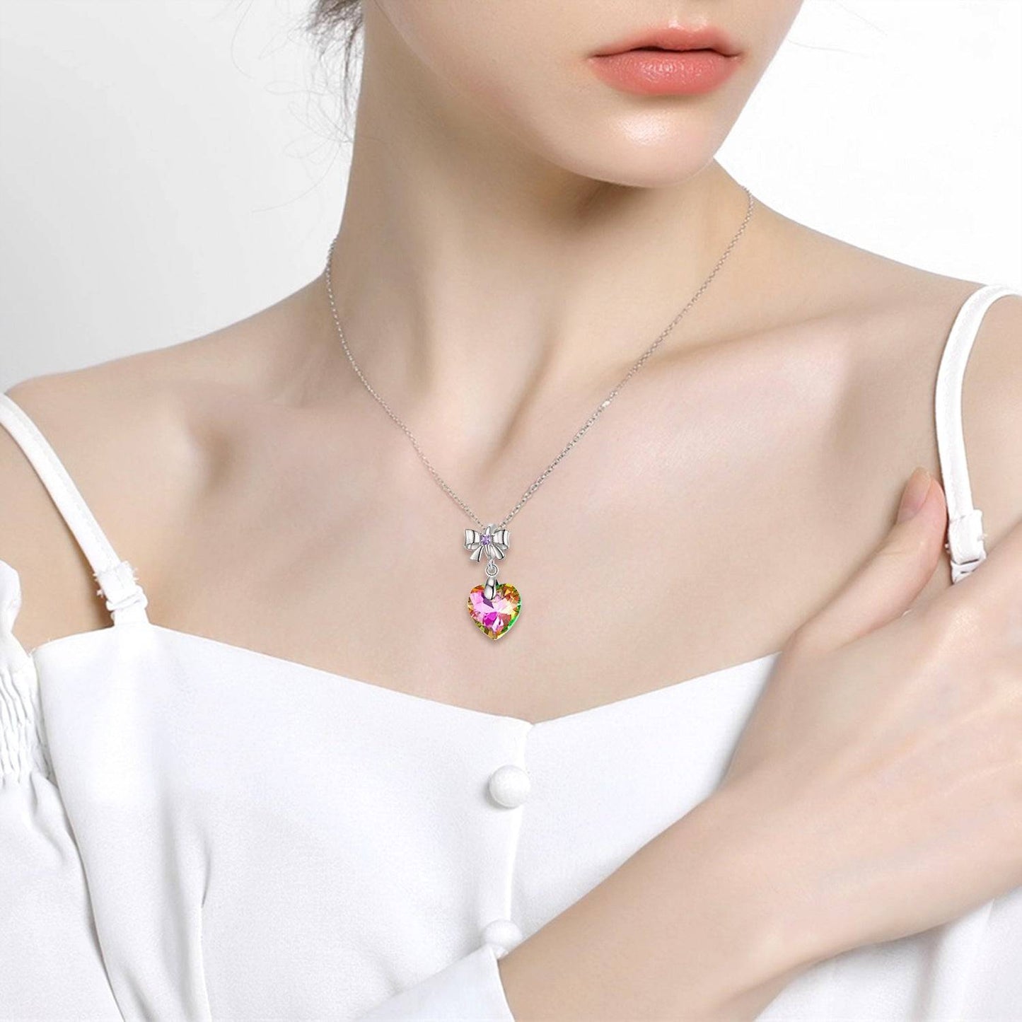 Woman wearing necklace with crystal heart charm